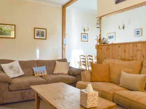 a living room with two couches and a table at Seasider in Whitby