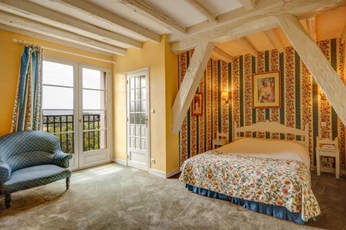 a bedroom with yellow walls and a bed and a chair at Château de Castel Novel Boutique Hôtel in Varetz
