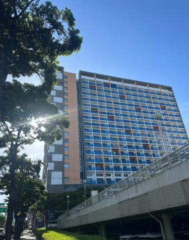 a tall building with a bridge in front of it at Jeju The Terrace View in Jeju