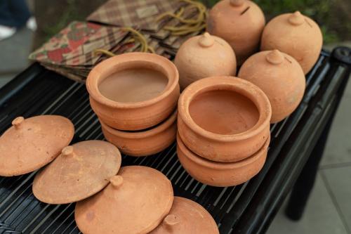 a group of clay pots sitting on a grill at HOI AN HISTORIC HOTEL in Hoi An