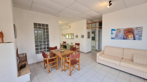 a living room with a table and a couch at la casa nell'acqua in Otranto