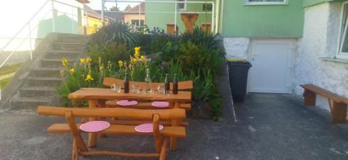 a table and two chairs and a table and flowers at KOÓS VENDÉGHÁZ in Uppony