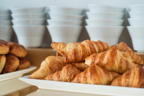 a plate of croissants and other pastries on a table at Art Hotel City Leipzig in Leipzig