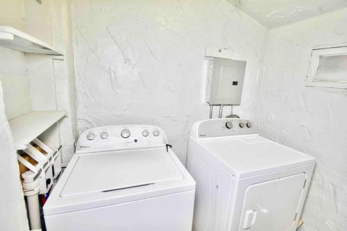 a white laundry room with a washer and dryer at Entire Home Near UTEP in El Paso