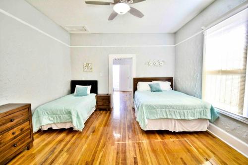 a bedroom with two beds and a ceiling fan at Entire Home Near UTEP in El Paso