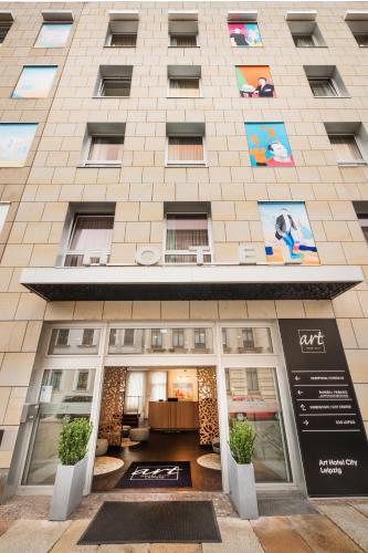 a building with a sign on the front of it at Art Hotel City Leipzig in Leipzig