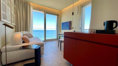 a living room with a couch and a red dresser at Opera Suite Hotel Pesaro in Pesaro