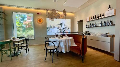 a restaurant with a table and chairs in a room at Opera Suite Hotel Pesaro in Pesaro