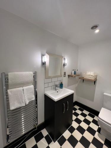 a bathroom with a sink and a toilet at Stags Head Inn in Yarlington