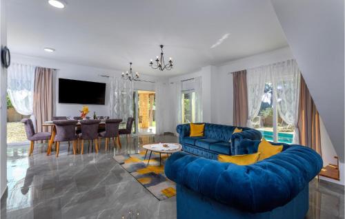 a living room with a blue couch and a table at Beautiful Home In Pinezici With Kitchen in Pinezici