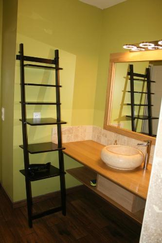 a bathroom with a sink and a mirror at La Maison De Lena in Grézillac