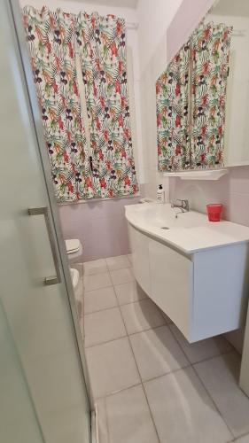a bathroom with a sink and a shower curtain at la casa nell'acqua in Otranto