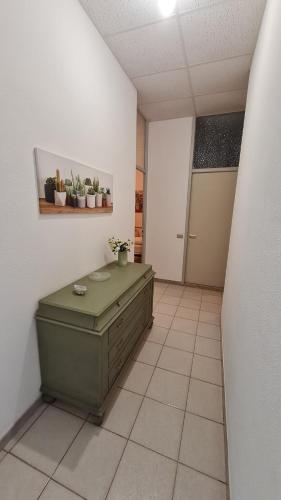a room with a green cabinet in the middle of a room at la casa nell'acqua in Otranto
