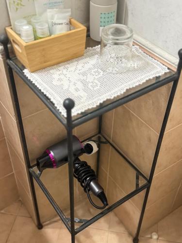 a table with a hair dryer and a glass on it at Cà del Vescovo in Imperia