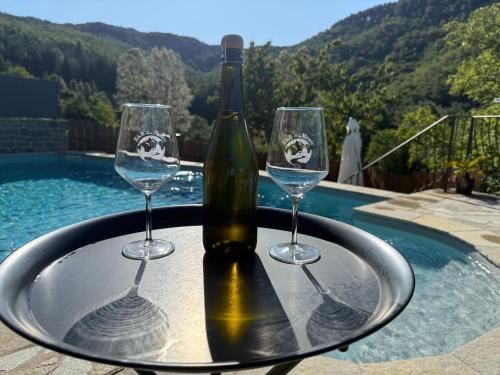 a bottle of wine sitting on a table with two wine glasses at B&B A…Monte in Santa Maria