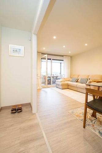 a living room with a couch and a table at Avalón I By Silastur in Villaviciosa
