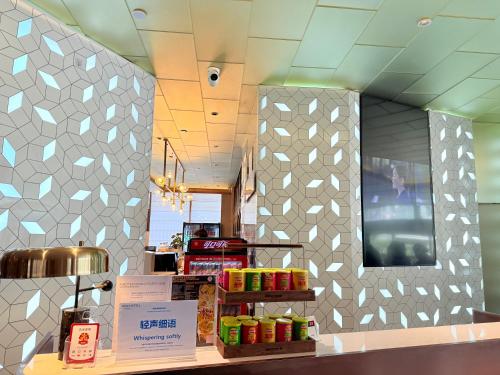 a restaurant with a counter with food on it at Novotel Xi'an The Bell Tower in Xi'an