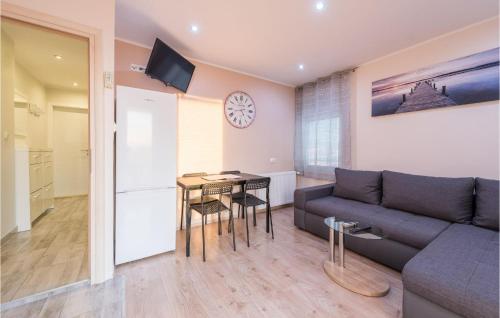 a living room with a couch and a table at Gorgeous Apartment In Sukosan in Sukošan