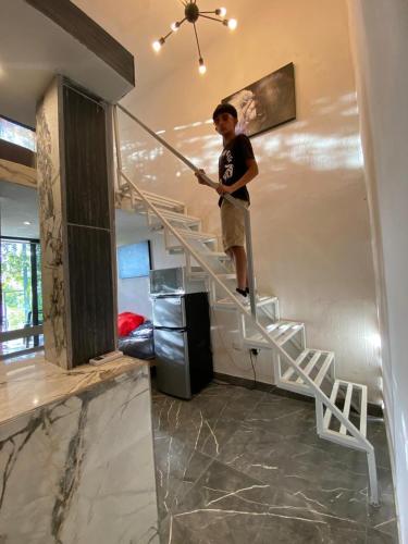 a man standing on a stairs in a room at private loft, comfortable, equipped, we invoice, in Torreón