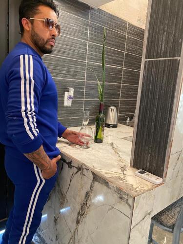 a man standing next to a counter with a glass at private loft, comfortable, equipped, we invoice, in Torreón