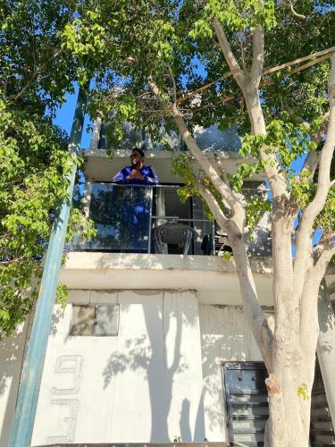 a man standing on the balcony of a house at private loft, comfortable, equipped, we invoice, in Torreón