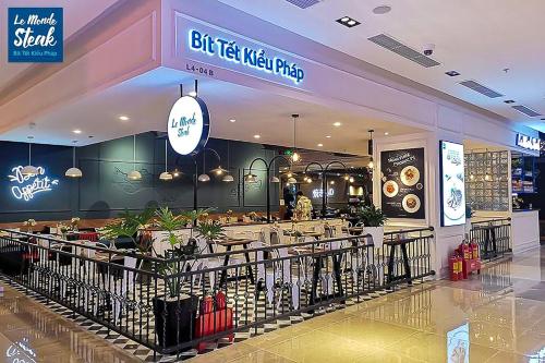 a food court in a shopping mall with a restaurant at Tami Homes - Vinhomes D'Capitale Executive Apartment in Hanoi