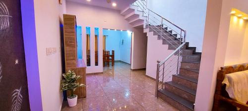 a hallway with a staircase in a house at Sands Villa Homestay in Wayanad
