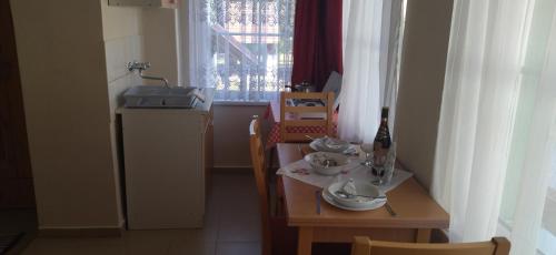 a kitchen with a table with dishes on it at KOÓS VENDÉGHÁZ in Uppony