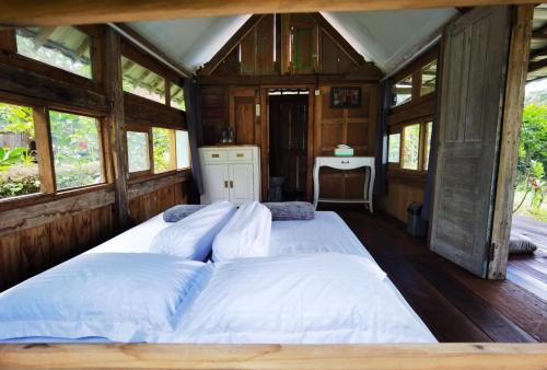 Ένα ή περισσότερα κρεβάτια σε δωμάτιο στο Homestay Ijen Lemon House