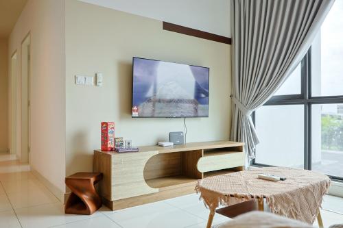 a living room with a tv on a wall at Greenfield Residence, Bandar Sunway by The Comfort Zone in Petaling Jaya