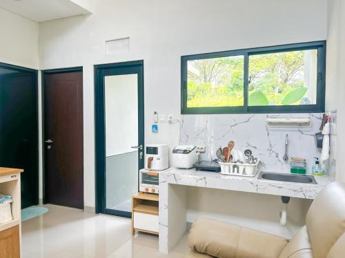 a kitchen with a sink and a window at Rumah Mungil Nyaman in Muara