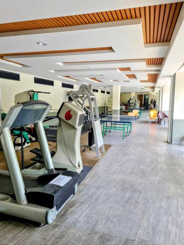 a gym with treadmills and a treadmill at Rumah Mungil Nyaman in Muara