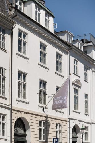 a white building with a sign on it at The Churchill manor apartments by Daniel&Jacob's in Copenhagen