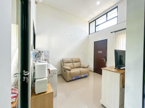 a living room with a couch and a chair at Rumah Mungil Nyaman in Muara