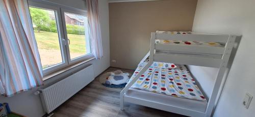 Ένα ή περισσότερα κρεβάτια σε δωμάτιο στο Ferienhaus an der Ölmühle