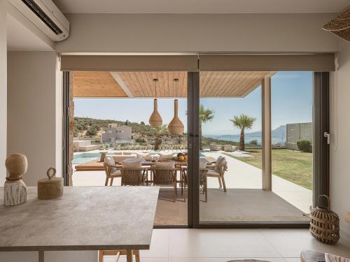 a dining room with a view of the ocean at Villa Niolos I in Marathi