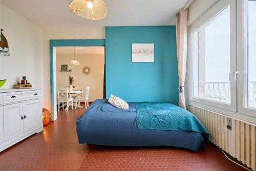 - une chambre bleue avec un lit et une table dans l'établissement Le Marin - Les Demeures d'Adrien, à Neufchâtel-Hardelot