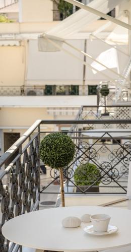 a white table with a plant on a balcony at Etoile Luxury Suites in Argostoli