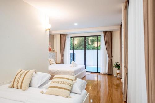 Postel nebo postele na pokoji v ubytování Nimo villa