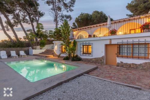 a house with a swimming pool in front of it at Villa Buenos Aires by Abahana Villas in Rada de Moraira