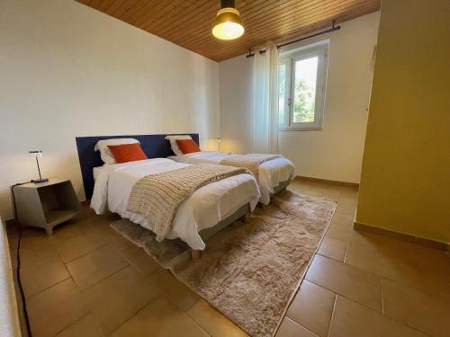 a bedroom with two beds and a window at La Villa 101 -TOPVACANCES -LES ISSAMBRES in Roquebrune-sur-Argens