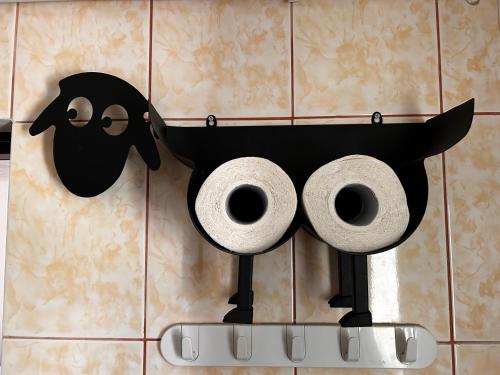 a couple of rolls of toilet paper on a wall at Studio Chic Elena in Năvodari