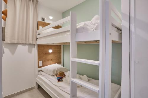 a room with two bunk beds in it at Résidence Odalys Riviera in Hyères