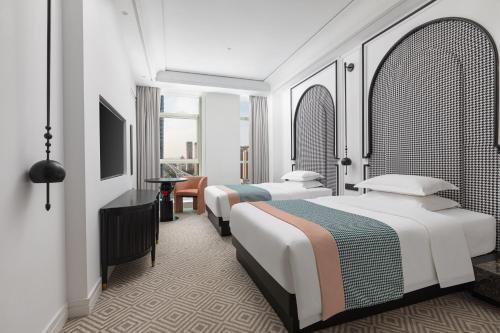 Ένα ή περισσότερα κρεβάτια σε δωμάτιο στο Wyndham Garden Wuhan Hankou