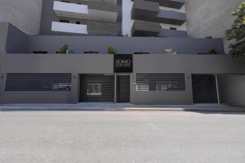 a building with two garage doors with a sign on it at Sokio Attiki Hotel, BW Premier Collection in Athens