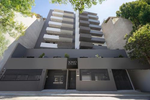 a building with a parking lot in front of it at Sokio Attiki Hotel, BW Premier Collection in Athens