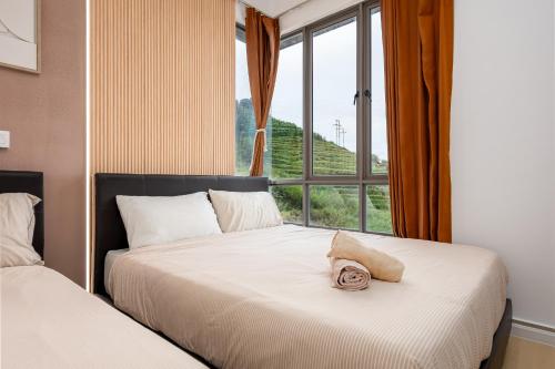 a bedroom with two beds and a window at Serene Japandi Family Retreat 2-6 pax& Sunrise View in Brinchang
