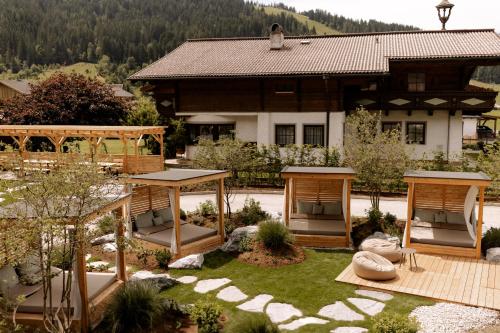 a house with a garden in front of it at Hotel Pongauerhof in Flachau