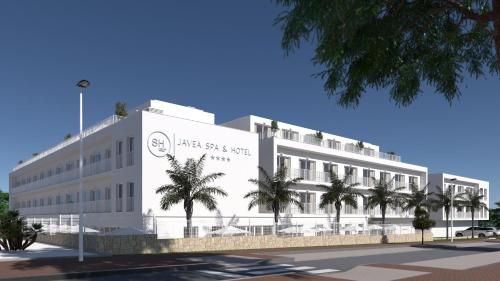 a large white building with palm trees in front of it at SH Jávea in Jávea
