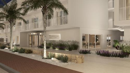 a building with palm trees in front of it at SH Jávea in Jávea